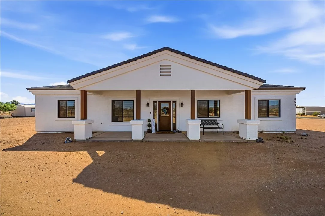 Original listing photograph of the Salt Place exterior, garage and desert setting